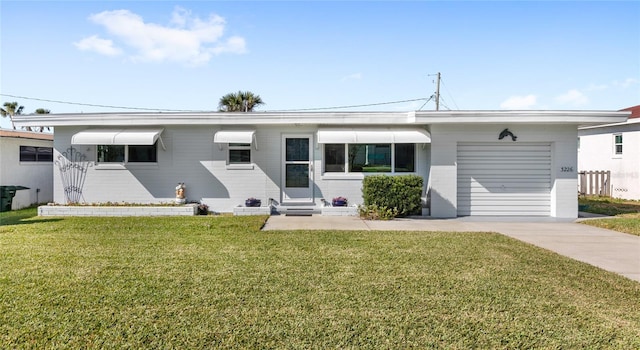 ranch-style house with entry steps, a garage, a front lawn, and concrete driveway