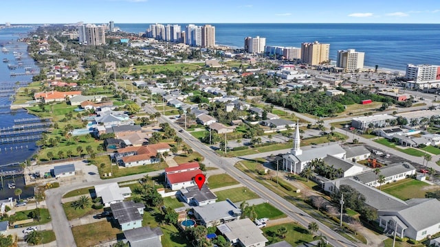 birds eye view of property with a water view and a city view