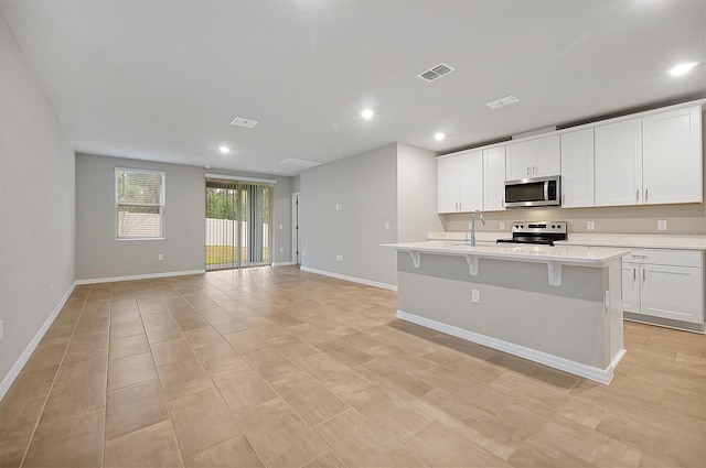 kitchen featuring light countertops, appliances with stainless steel finishes, a sink, and visible vents