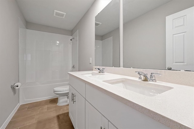 bathroom featuring visible vents, a sink, toilet, and double vanity