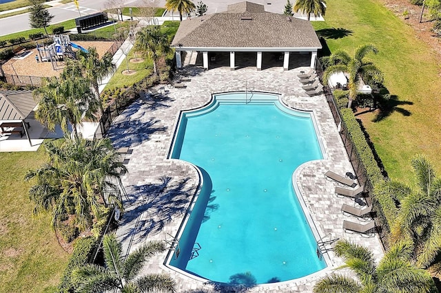 pool with a patio and fence