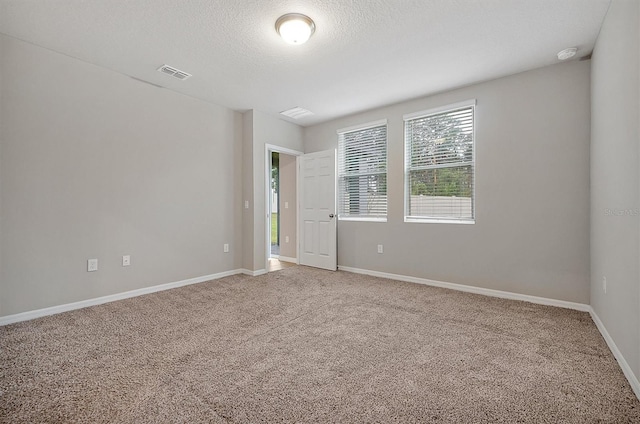 869 Rivers Crossing St, Clermont, FL 34714 - unfurnished room with light colored carpet, baseboards, a textured ceiling, and a smoke detector
