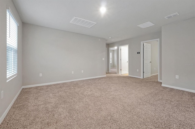 869 Rivers Crossing St, Clermont, FL 34714 - spare room featuring light carpet, healthy amount of natural light, and baseboards