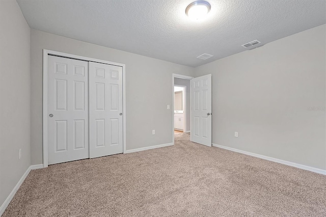 869 Rivers Crossing St, Clermont, FL 34714 - unfurnished bedroom with carpet floors, a textured ceiling, baseboards, and a closet