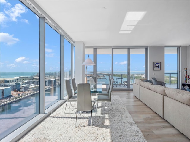 sunroom / solarium featuring a water view