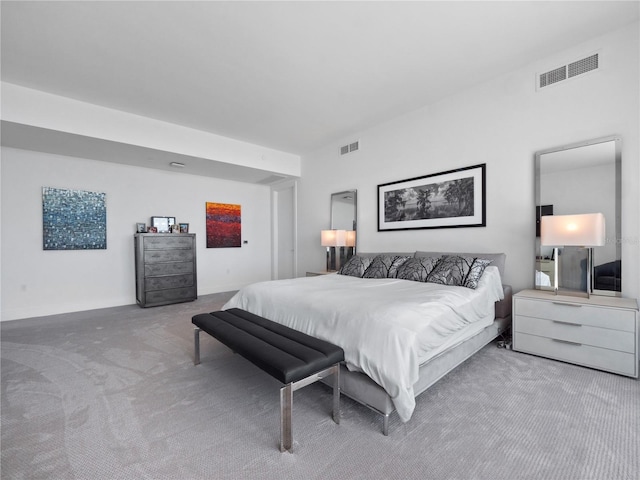 carpeted bedroom with visible vents and baseboards