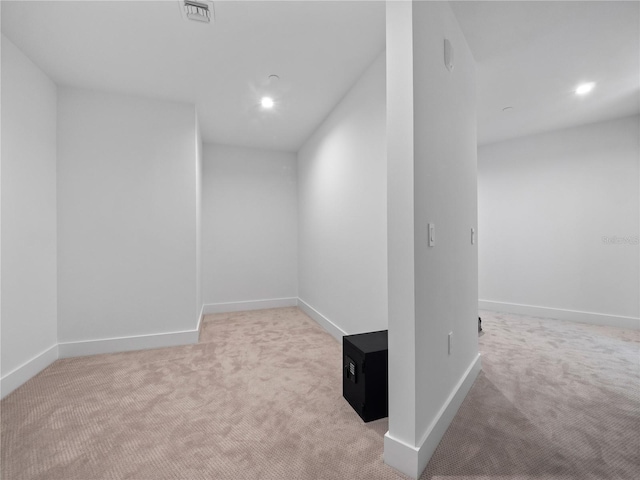 carpeted empty room featuring baseboards and visible vents