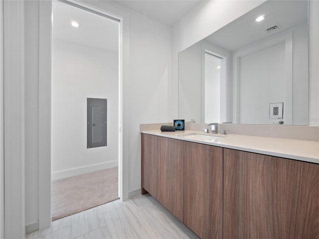 bathroom with electric panel, visible vents, vanity, and baseboards