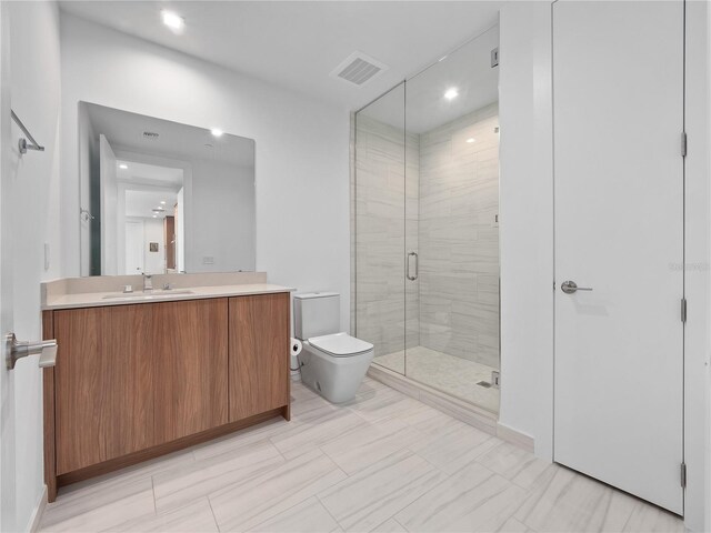 full bath with visible vents, toilet, a stall shower, and vanity