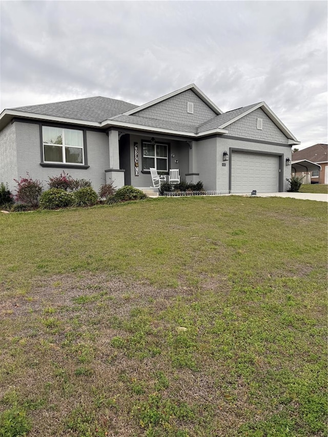 view of front facade with driveway, an attached garage, a front yard, a porch, and stucco siding