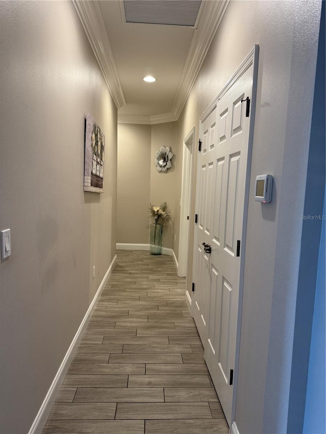 corridor with crown molding, recessed lighting, visible vents, wood tiled floor, and baseboards