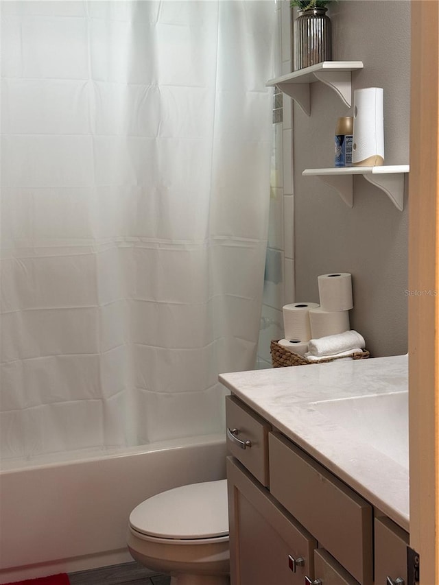 bathroom featuring shower / tub combo and toilet