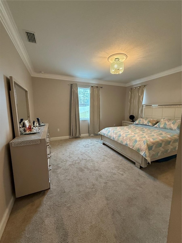 bedroom with baseboards, visible vents, crown molding, and carpet flooring