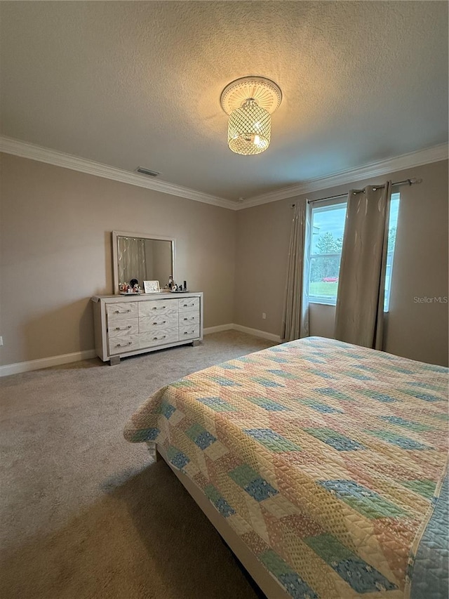 unfurnished bedroom with visible vents, ornamental molding, carpet flooring, a textured ceiling, and baseboards