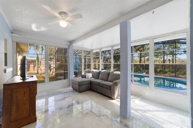 sunroom featuring ceiling fan