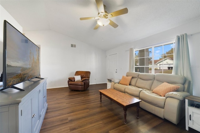 living room with dark wood-style flooring, lofted ceiling, visible vents, ceiling fan, and baseboards