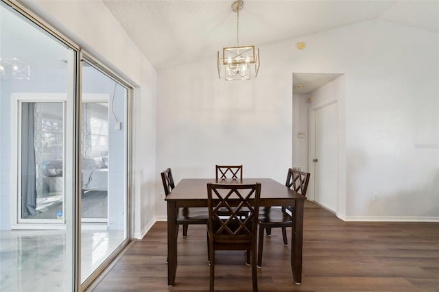 dining room with dark wood-type flooring, lofted ceiling, a notable chandelier, and baseboards