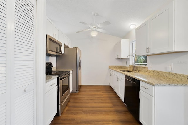 kitchen with dark wood finished floors, appliances with stainless steel finishes, a textured ceiling, white cabinetry, and a sink