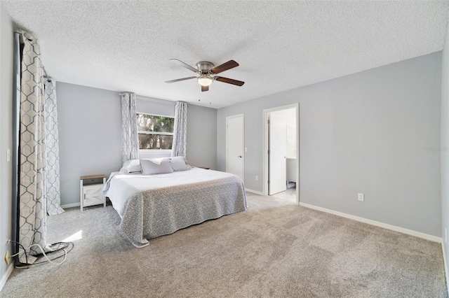 bedroom with ceiling fan, a textured ceiling, carpet flooring, and baseboards