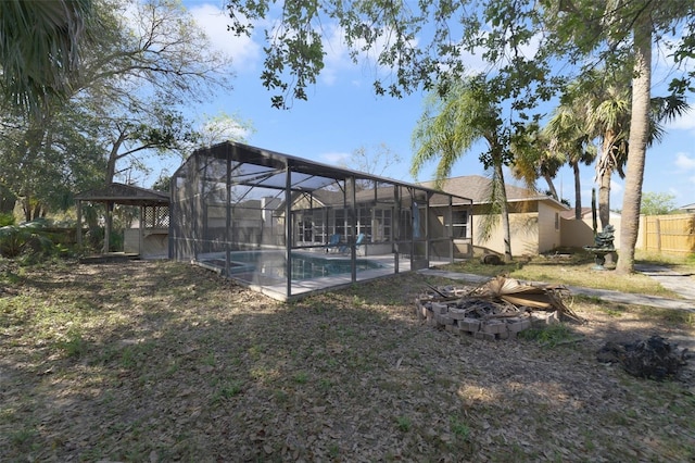 outdoor pool with a patio area, fence, and a lanai