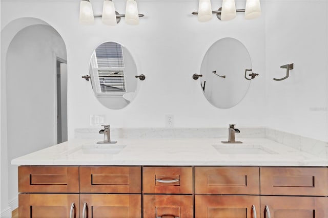 full bathroom featuring double vanity and a sink