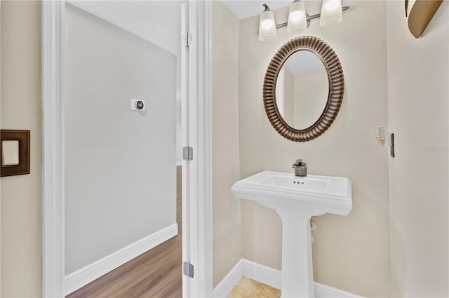 bathroom featuring baseboards and wood finished floors