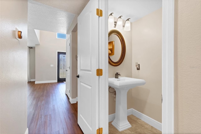 bathroom featuring baseboards and wood finished floors