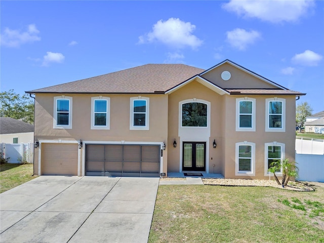 view of front of property with driveway, fence, and stucco siding