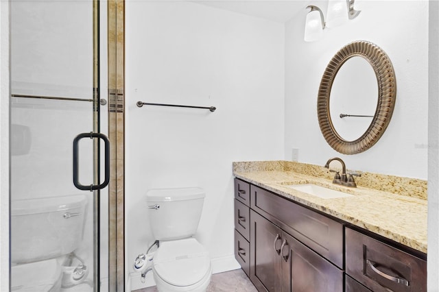 full bathroom with baseboards, a shower stall, toilet, and vanity