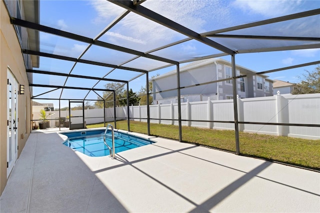 view of swimming pool with a patio, a fenced backyard, glass enclosure, and a fenced in pool