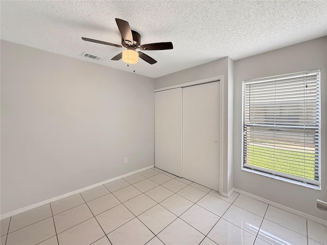 unfurnished bedroom featuring a closet, visible vents, ceiling fan, and baseboards