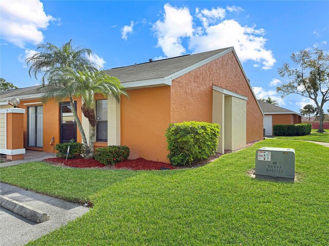 view of property exterior with a lawn and stucco siding