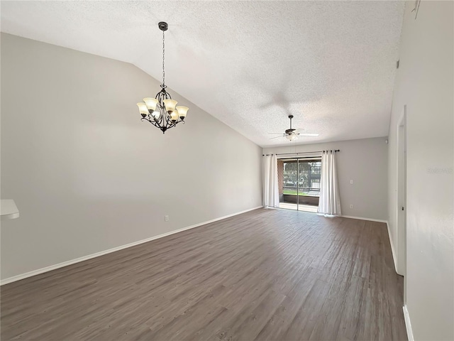 interior space featuring a textured ceiling, lofted ceiling, ceiling fan with notable chandelier, dark wood-style flooring, and baseboards