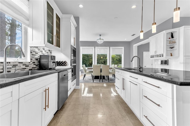 kitchen with stainless steel appliances, plenty of natural light, and a sink