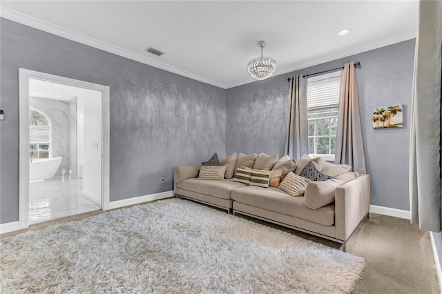 living area featuring baseboards, a wealth of natural light, visible vents, and crown molding