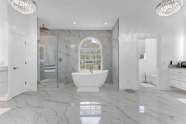 bathroom with a chandelier, marble finish floor, and vanity