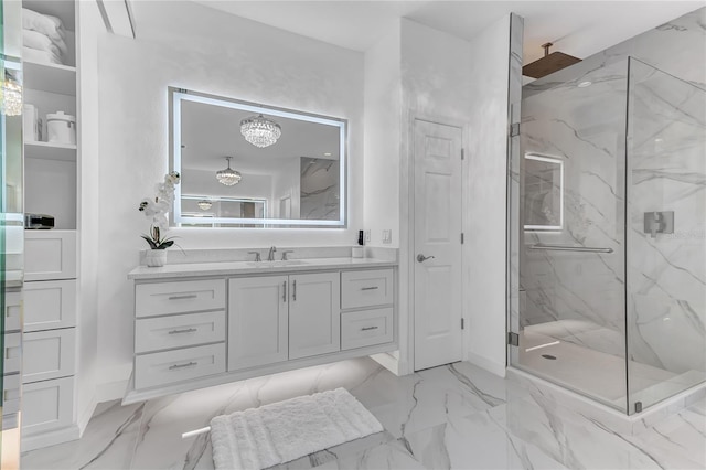 full bath with marble finish floor, baseboards, vanity, and a marble finish shower