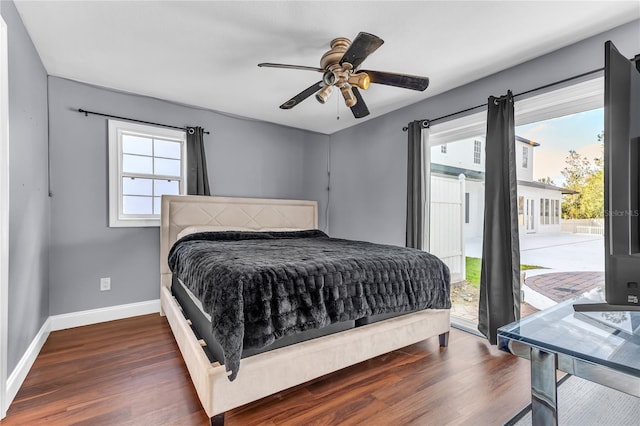 bedroom featuring access to outside, dark wood-style flooring, multiple windows, and baseboards