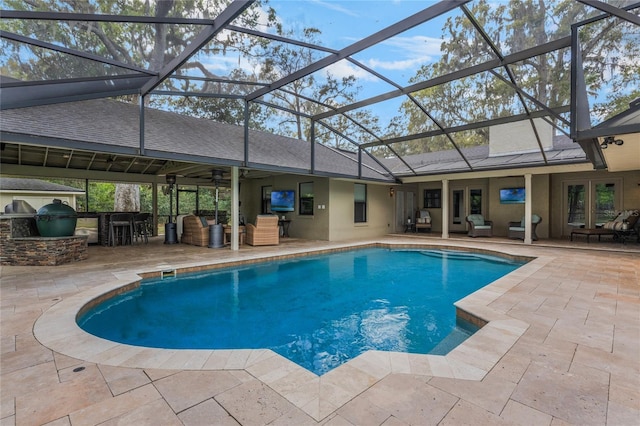 outdoor pool featuring a patio area, glass enclosure, an outdoor hangout area, and area for grilling