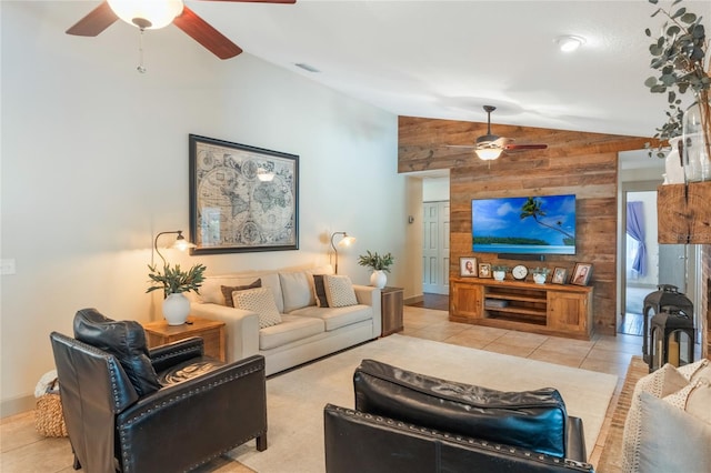 living area with light tile patterned floors, wooden walls, visible vents, a ceiling fan, and lofted ceiling