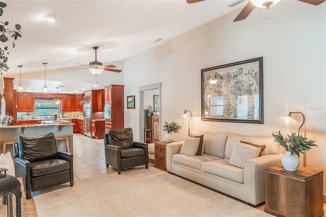 living area featuring high vaulted ceiling, ceiling fan, and light tile patterned floors