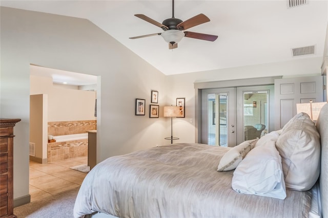 bedroom featuring access to exterior, french doors, light tile patterned floors, visible vents, and vaulted ceiling