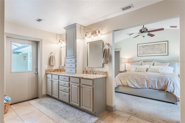 ensuite bathroom featuring connected bathroom, visible vents, a sink, and double vanity