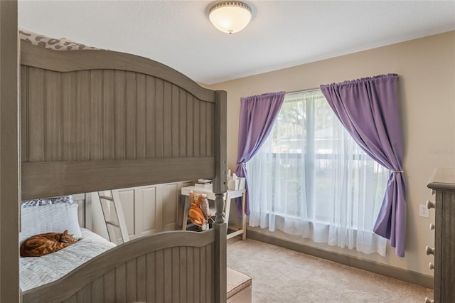 carpeted bedroom featuring baseboards