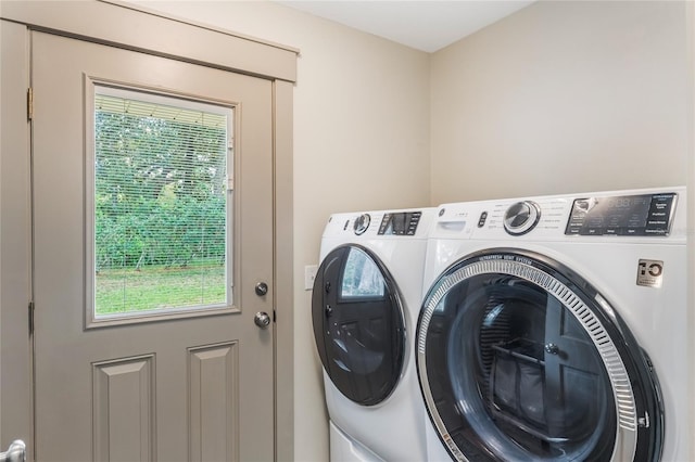 washroom featuring laundry area and washing machine and dryer