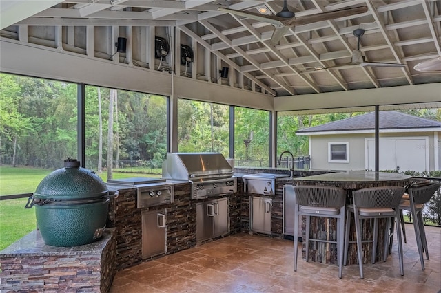 sunroom / solarium featuring a healthy amount of sunlight and vaulted ceiling with beams