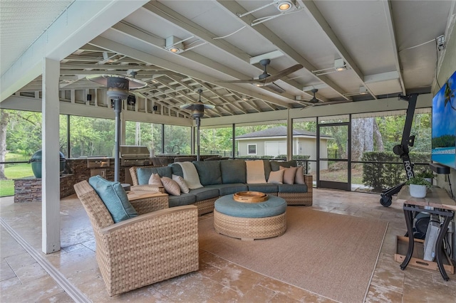 sunroom / solarium with vaulted ceiling and a ceiling fan