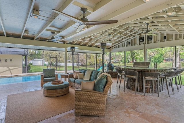 sunroom / solarium featuring lofted ceiling and a ceiling fan