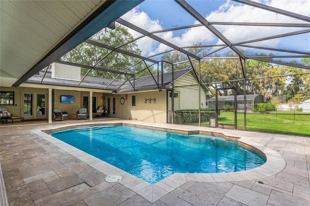 outdoor pool with a patio, glass enclosure, fence, french doors, and a lawn