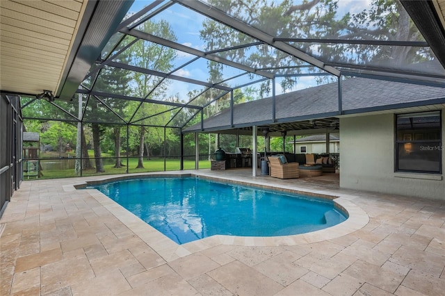 pool with a patio area, glass enclosure, and outdoor lounge area